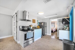 A modern kitchen with stainless steel appliances, a built-in oven, and a microwave.