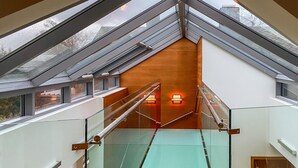 A modern interior with a glass staircase leading to a wooden ceiling. - Pet friendly home in ålesund (Ålesund)