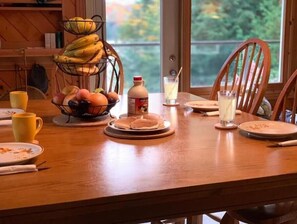 Guests can enjoy a homey breakfast in this dining area with a table set for a meal.