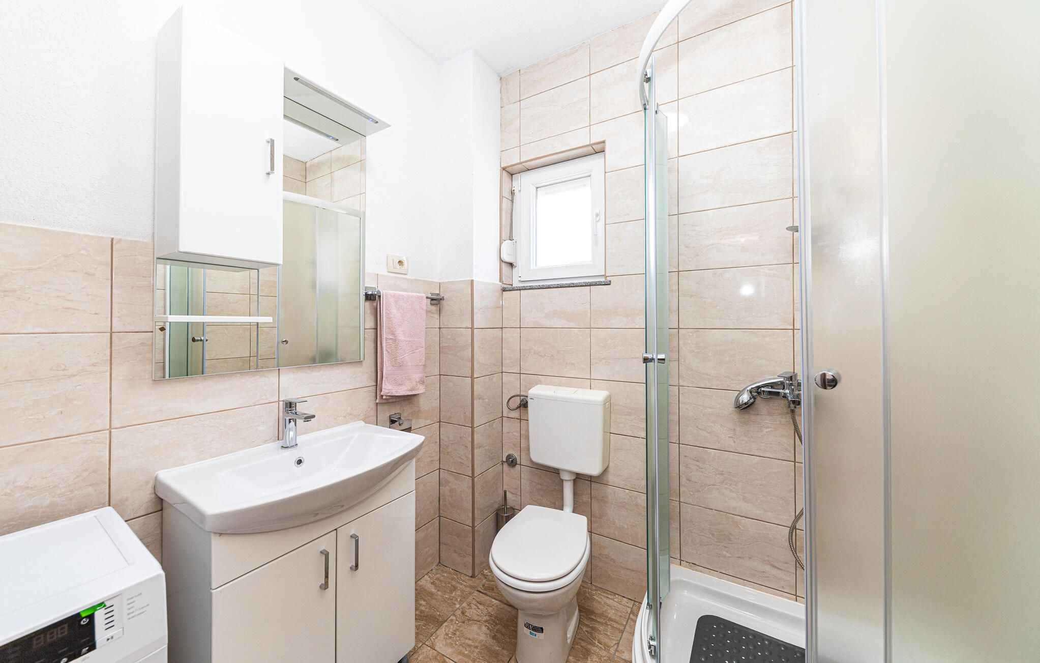 A bathroom with a sink, toilet, and shower.