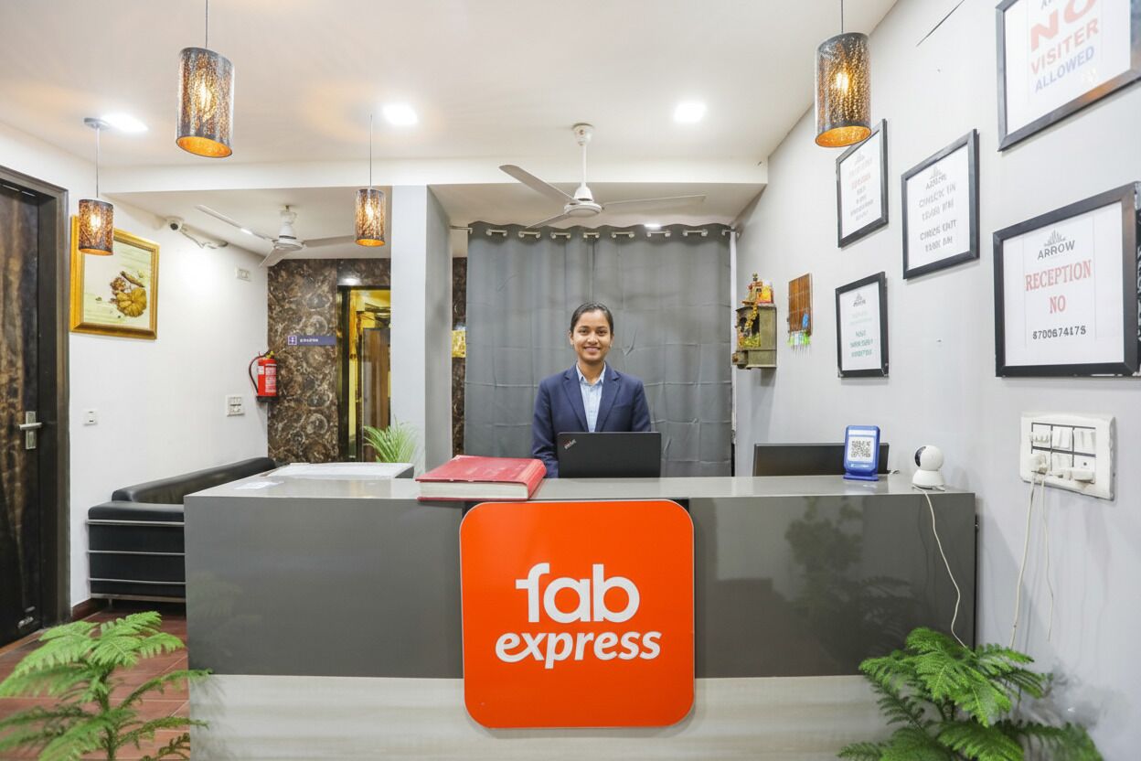 A reception desk with a sign reading "fab express" and a person seated behind it.
