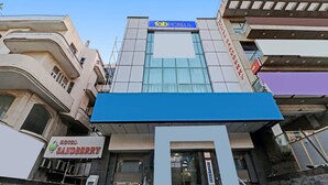 A building with a 'fab hotels' sign and a 'Hotel Sandberry' sign. - FabHotel Rayplus (New Delhi)