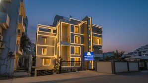 A modern building with a sign for 'Majestic Fab Hotels'. - Fabhotel Majestic Luxurious (Pune)