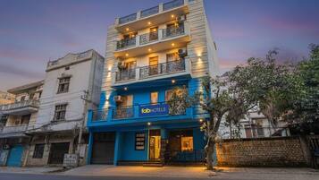 A multi-story building with a blue facade and balconies, labeled as 'fab hotels'.