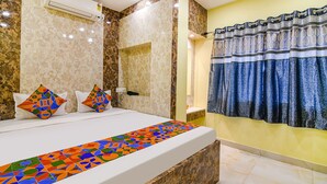 A hotel room with a bed, a bathroom, and a shower area. - Fabhotel Divine Chariot (Barasat)