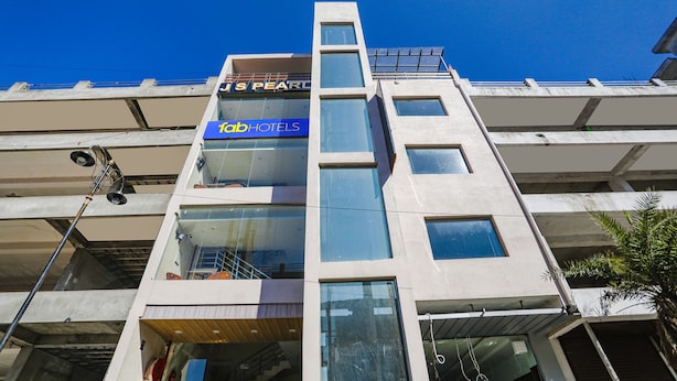 A multi-story building with a 'fabr hotels' sign on the second floor. - Fabhotel Js Pearl (Dehradun)