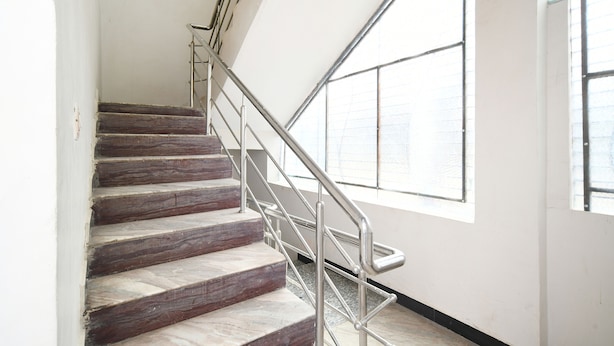 A staircase with metal railings and large windows.
