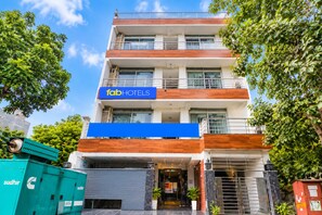 A multi-story hotel with a prominent 'fab hotels' sign, a covered entrance, and a modern facade. - FabHotel Roadway Inn (New Delhi)
