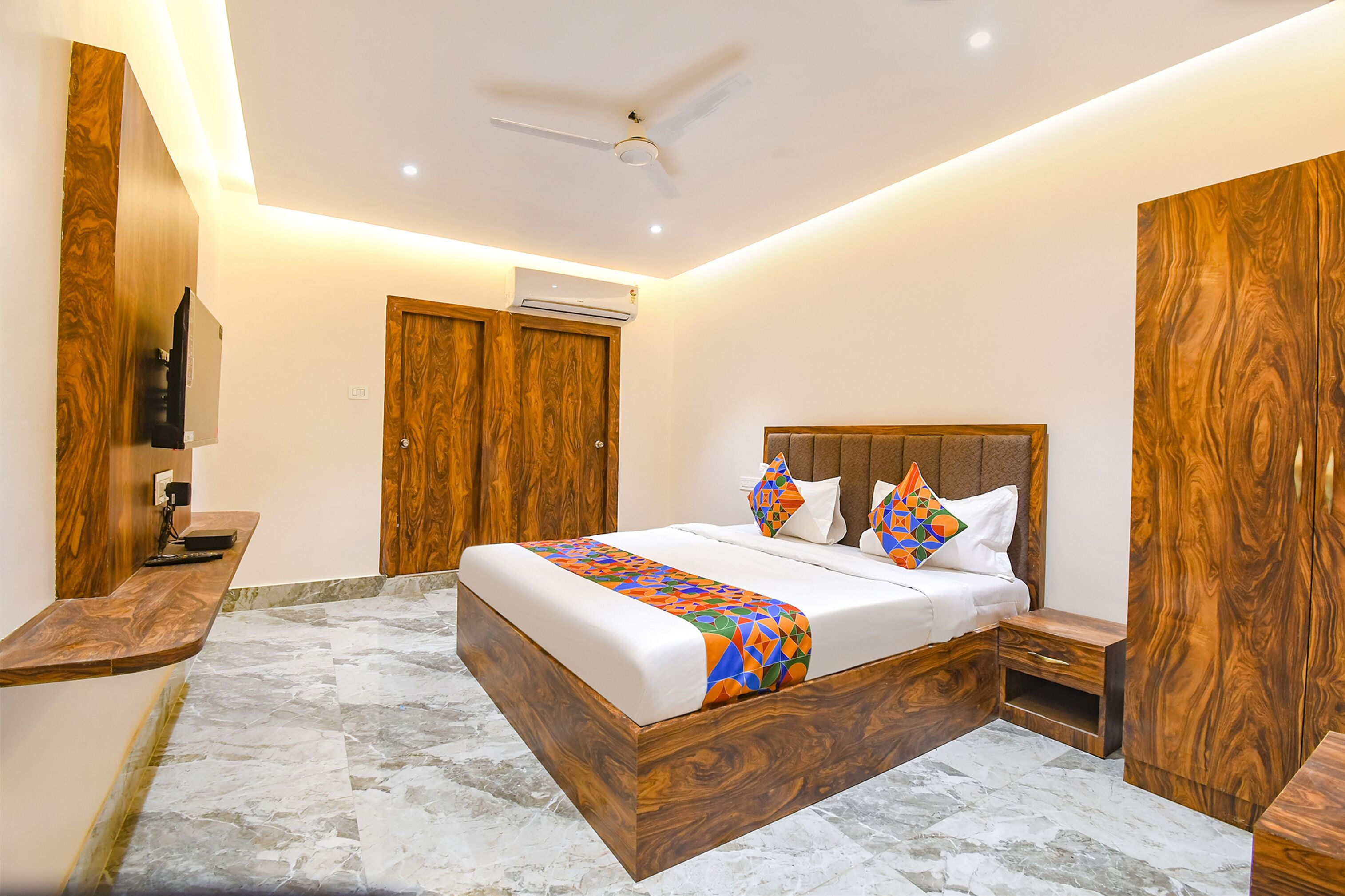 A bedroom with a wooden bed, a ceiling fan, and a marble floor.