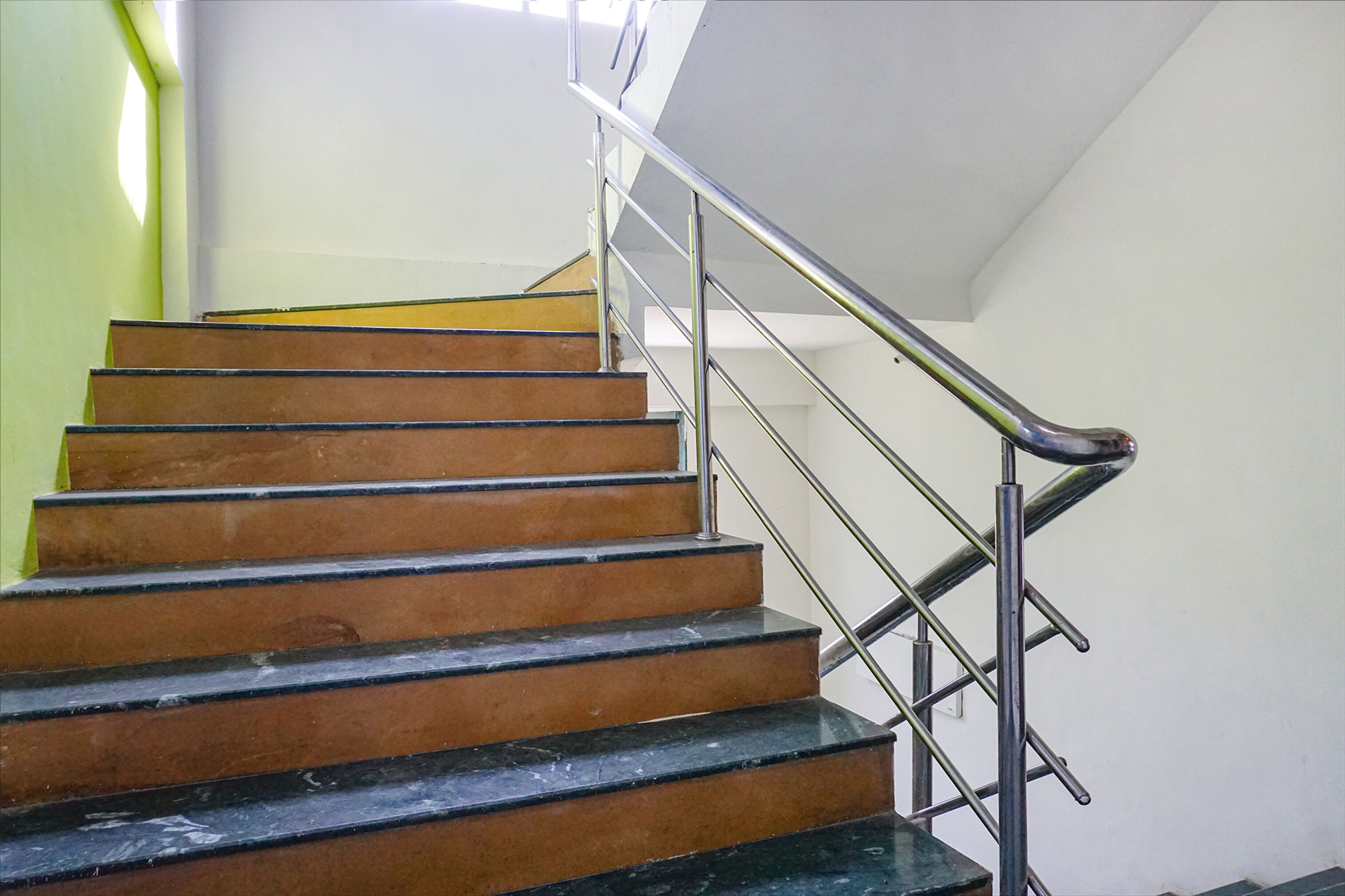 A staircase with metal railings and wooden steps.