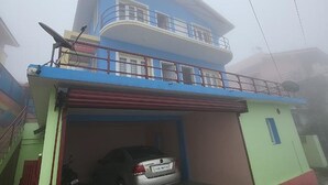 A two-story building with a car parked in the garage.