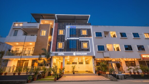 A hotel with a modern design, featuring a restaurant and a metro station sign. - Fabhotel Aashiyana (Indore)