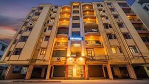 A multi-story hotel with a central entrance, balconies on each floor, and a sign for 'FadHotels'. - Fabhotel Maadhavam Residence (Patna)