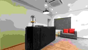 Una sala moderna con un mueble multimedia negro, un sofá rojo y una alfombra estampada.