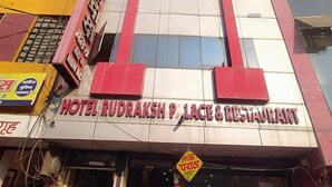 The exterior of Hotel Rudraksh P. Laces & Restaurant with a prominent signboard. - Fabexpress Rudraksh Palace (Ujjain)