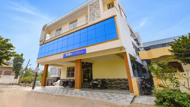 A two-story building with a blue facade and a sign reading "Tab Hotels". - Fabhotel Living (Jaipur)