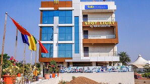 A modern hotel with a blue and white facade, a visible sign for 'FAB HOTELS', and a 'SPOT LIGHT AC / NON EXECUTIVE' sign. - Fabhotel Spot Light (Sasvad)