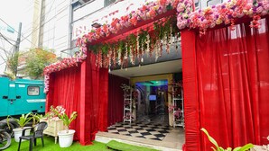 A stage with red curtains, potted plants, and a checkered floor. - Fabhotel Prime Blest Park (New Delhi)