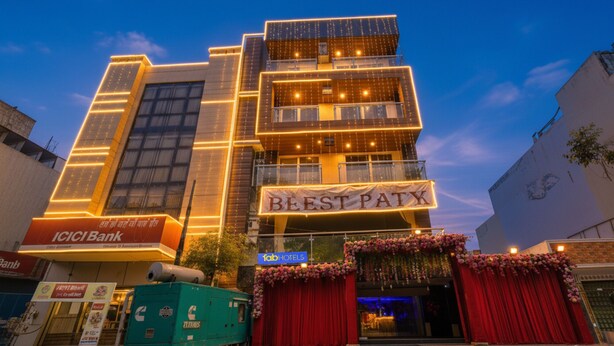 A multi-story building with illuminated signage for 'Best Paty' and 'ICICI Bank'. - Fabhotel Prime Blest Park (New Delhi)