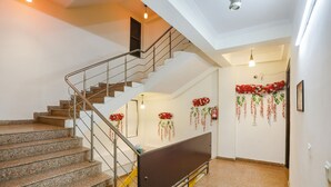 A staircase with granite steps and metal railings, leading to an upper floor. - Fabhotel Corporate Stay (Noida)