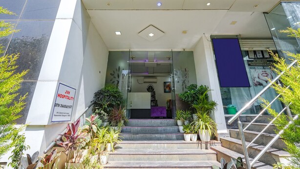 A hotel entrance with a staircase, glass doors, and potted plants. - FabHotel Upstream Sarjapur (Bengaluru)