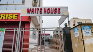 A gated entrance to a building with a sign reading "WHITE HOUSE". - Fabhotel White House I (Kolkata)