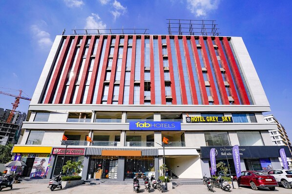 A hotel with a modern facade, multiple floors, and a prominent 'Tab Hotels' sign.