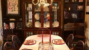 A dining table set with placemats, candles, and a glass centerpiece. - UPSCALE NE TALLAHASSEE QUIET, SECURE RESIDENCE FULLY EQUIPPED (Tallahassee)