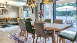 A modern living room with a dining area, large windows, and a view of the outdoors. - Villa Shea by Interhome (Labin)