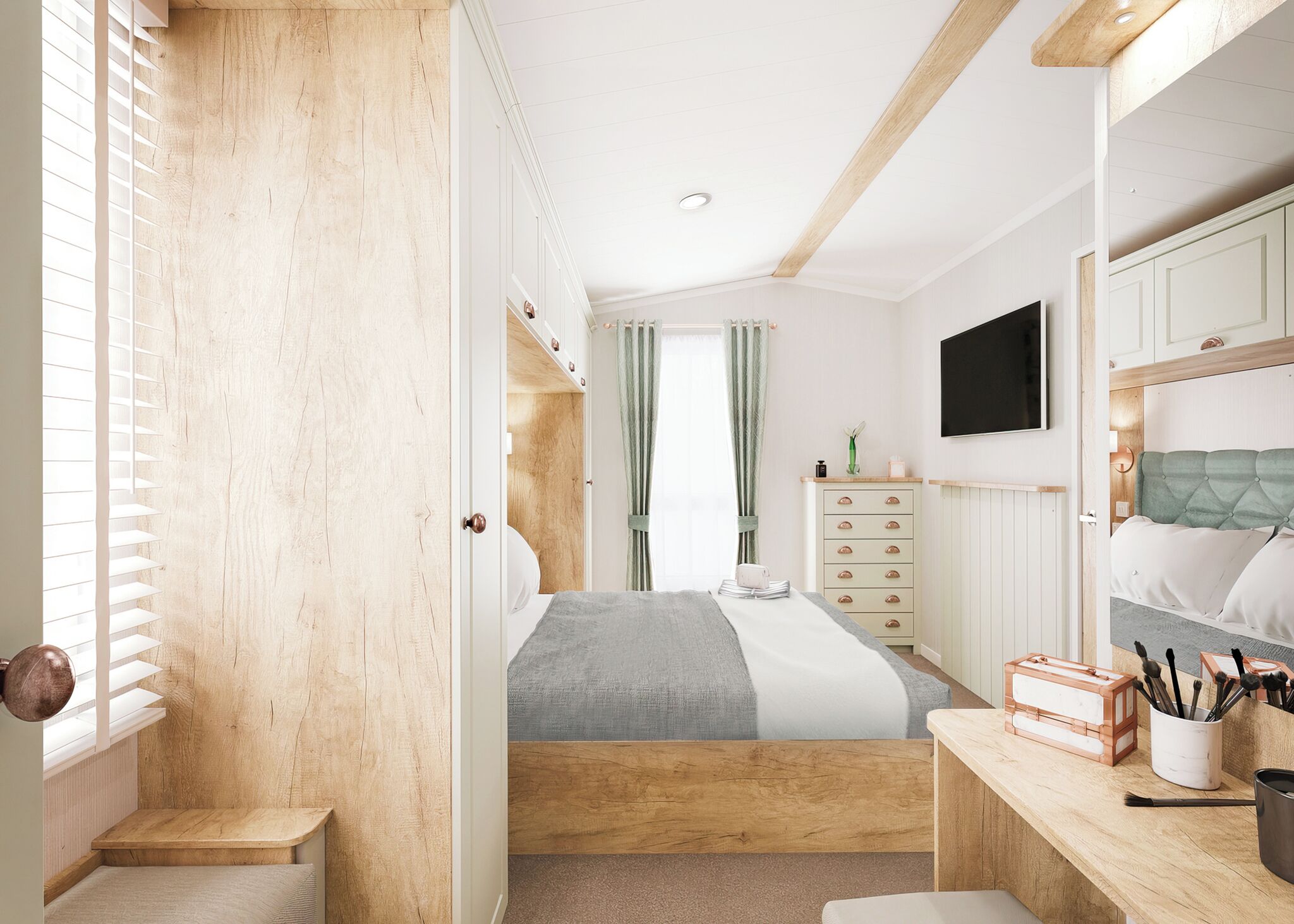 A bedroom with a bed, a dresser, a desk, and a television.