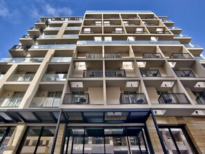 A multi-story building with balconies, large windows, and a modern architectural design. - Number 11 St Julian's Malta-handwritten Collection (St. Julian's)