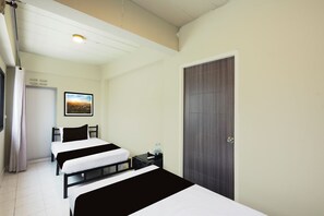 A hotel room with two beds, a nightstand, a door, and a framed picture on the wall. - RQ Bangkok Huai Khwang by Collection O (Bangkok)