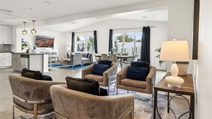 A spacious living area with a sofa set, a dining table, and a kitchen in the background. - 6 Bedrooms, 9 Beds, 3 Bathrooms, an 82° Heated Pool, & the BEST 102° Spillover Hot Tub in all of Old Town Scottsdale! (Scottsdale)