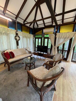 A room with a sofa, chairs, a coffee table, and a television. - Villa Sri Kampung  (Langkawi)