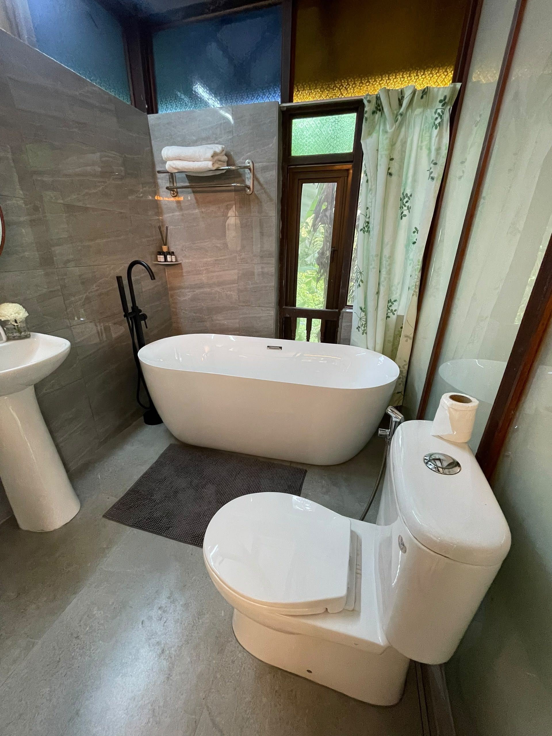A bathroom with a bathtub, toilet, and sink.