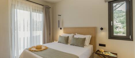 A neatly arranged bedroom with a bed, a bedside table, and a window.
