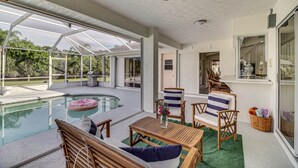 Area piscina scoperta coperta con mobili in legno, ventilatore a soffitto e vista sul paesaggio circostante.