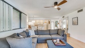 A modern living room with a sectional sofa, a coffee table, and a ceiling fan. - Condo in PGA National Resort w/ Pool & Spa! (Palm Beach Gardens)