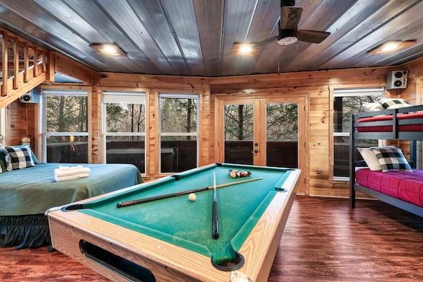 A wooden cabin with a pool table, two beds, and large windows. - 2 BED|2.5 BATH-Butterfly Views-Close to Dollywood! (Sevierville)