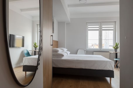 Hypo-allergenic bedding, laptop workspace, blackout drapes