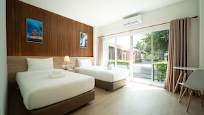 A hotel room with two beds, a desk, and a view of the outside. - B2 Nakhon Sawan Boutique & Budget Hotel (Nakhon Sawan)