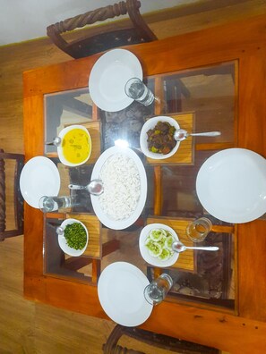 Dine in style with a beautifully set table, surrounded by comfortable chairs.