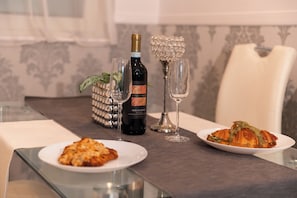 Wine and breakfast are served at this elegant dining table.