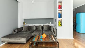 City Apartment | Living area | 40-inch Smart TV with cable channels