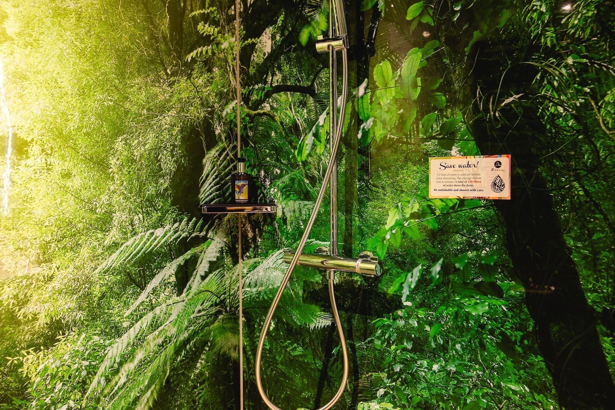 A shower with a sign encouraging water conservation.