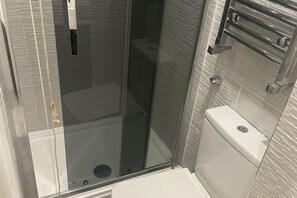Separate tub and shower, deep soaking tub, towels