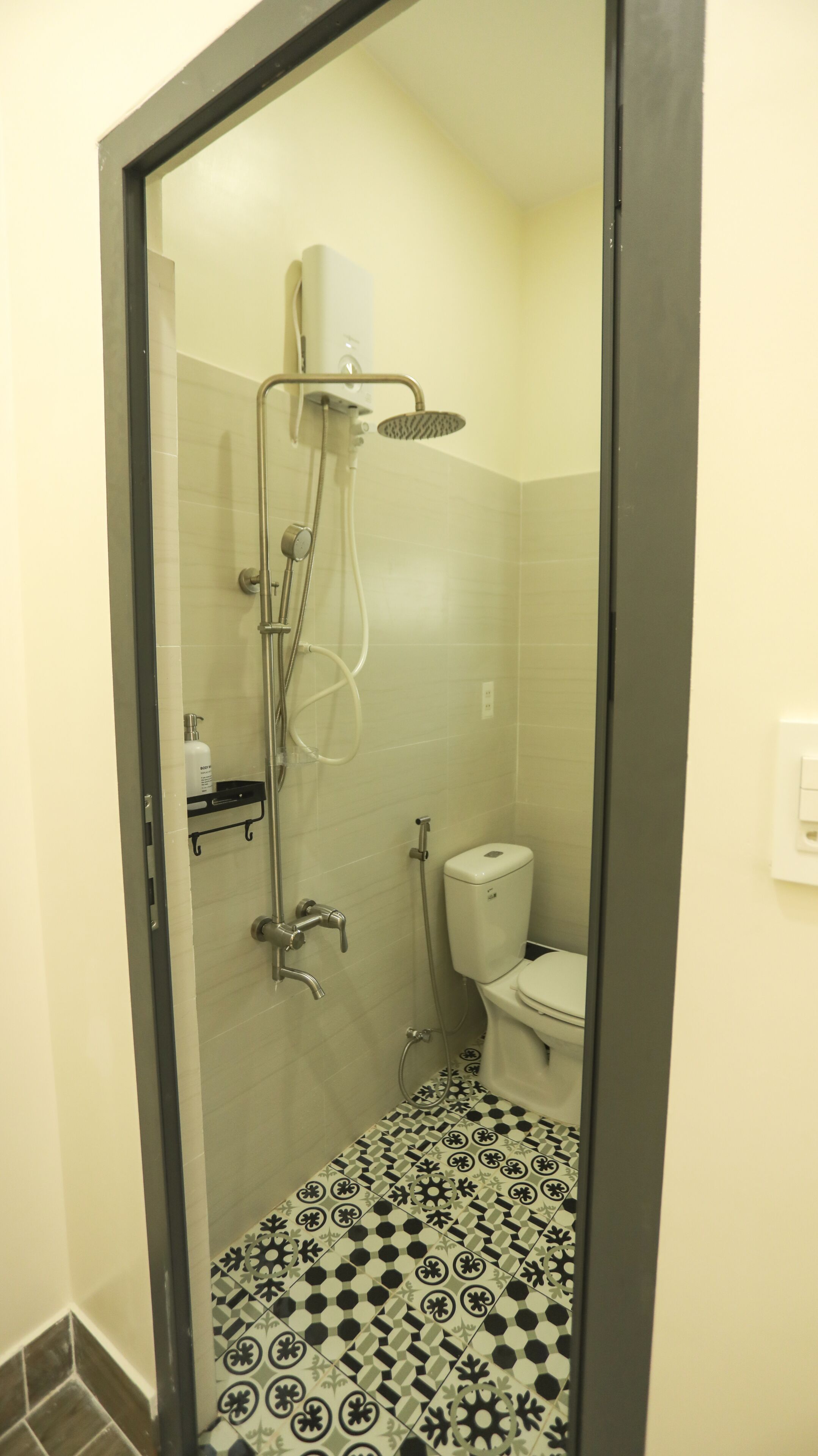 A small bathroom with a shower, toilet, and a sink.