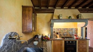A kitchen with a marble sink, wooden cabinets, a tiled backsplash, and a built-in oven. - Apartment in the tuscan countryside with pool (Sesto Fiorentino)