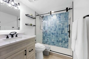 Shower, hair dryer, towels, shampoo