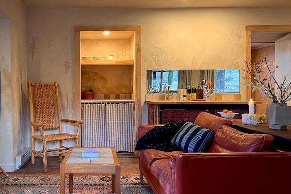 A seating area for four now greets you at the entrance of the room. Feel free to stay a while!